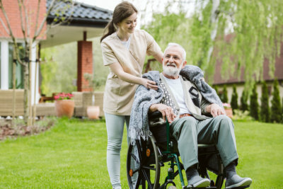 senior with helpful volunteer in the garden