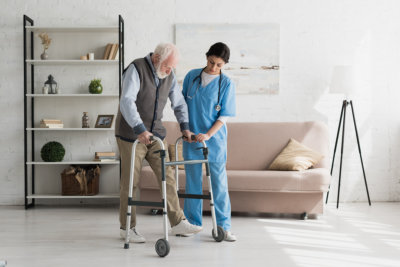 caregiver helping senior man