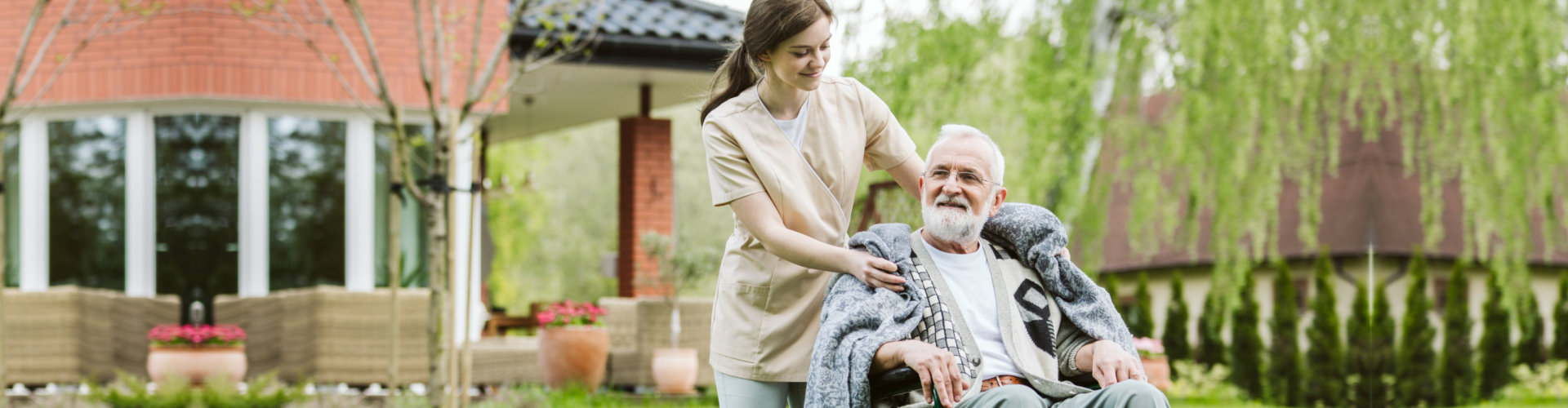 senior with helpful volunteer in the garden